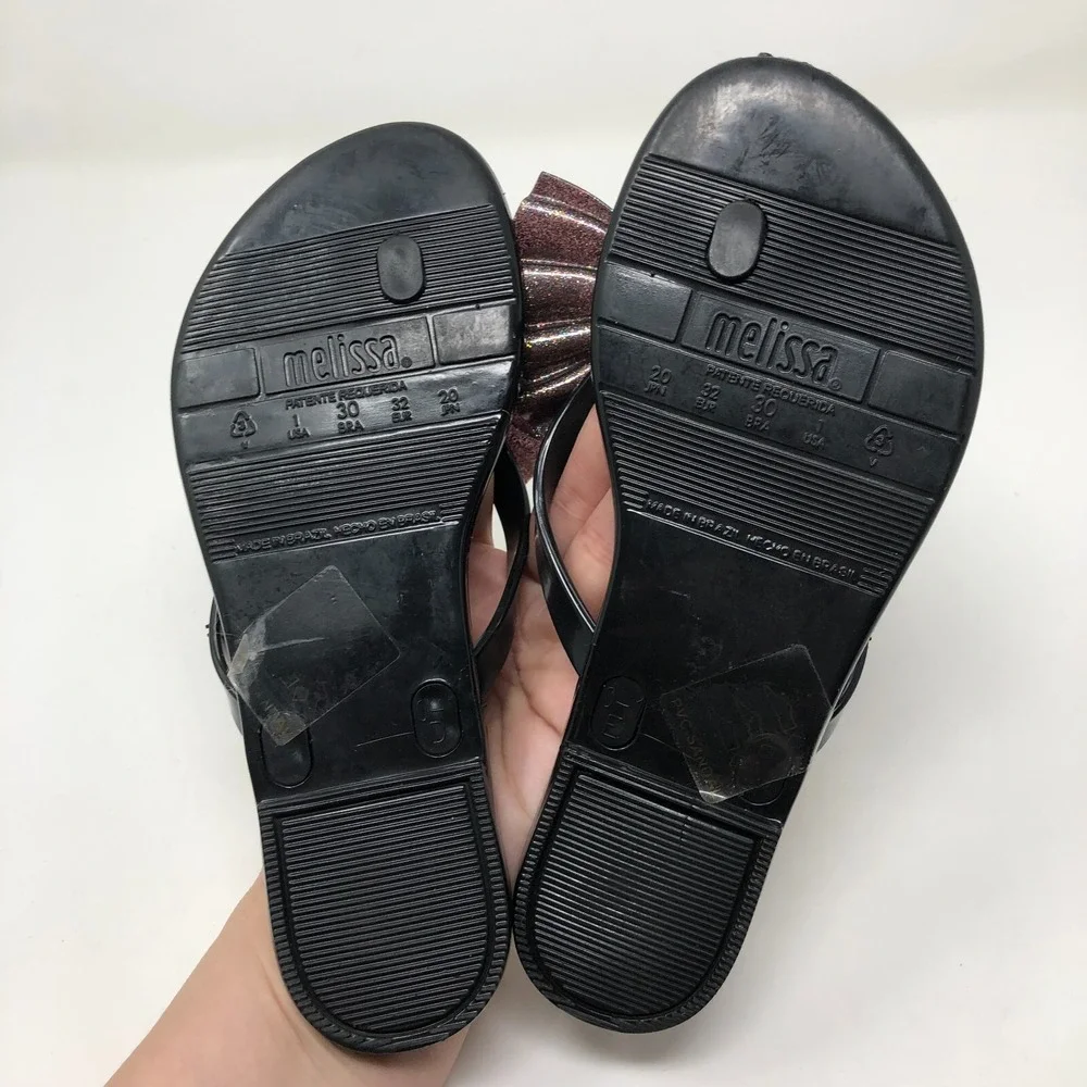 Melissa Mel Harmonic Bow Vi INF Flip Flops Girls 1 Black Glitter Scented